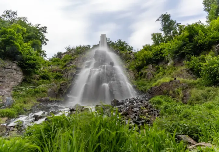 Der Trusetaler Wasserfall stürzt über Felsen in die Tiefe, umgeben von üppigem Grün.