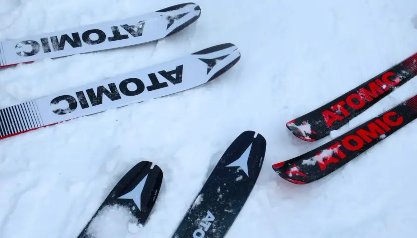 Atomic Backland 85 Test: Zwei Paar Atomic-Ski liegen im Schnee, bereit für den Einsatz.
