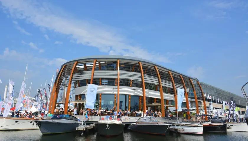 Boote liegen am Kai vor einem modernen Gebäude am NDSM Amsterdam.